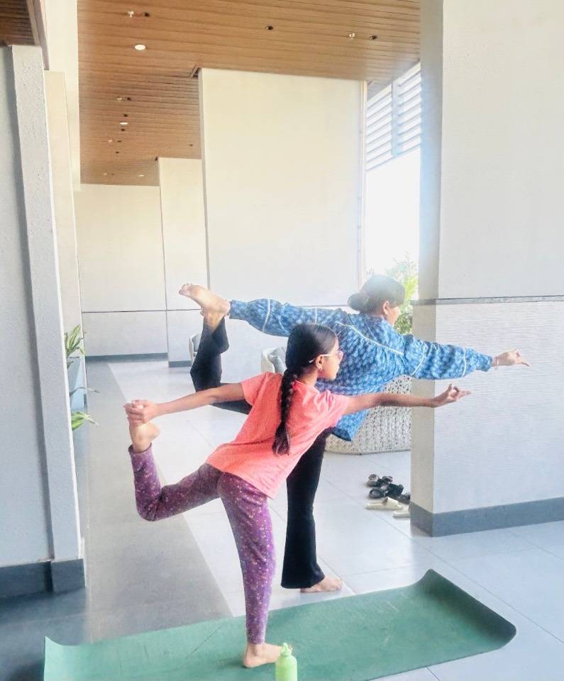 Parent and child in dancer pose together