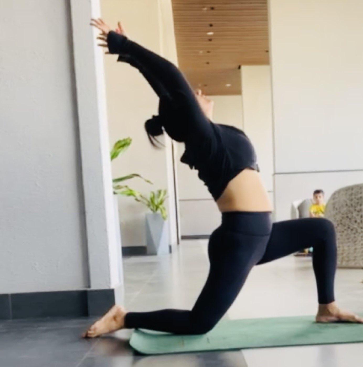 Pallavi guiding a yoga posture